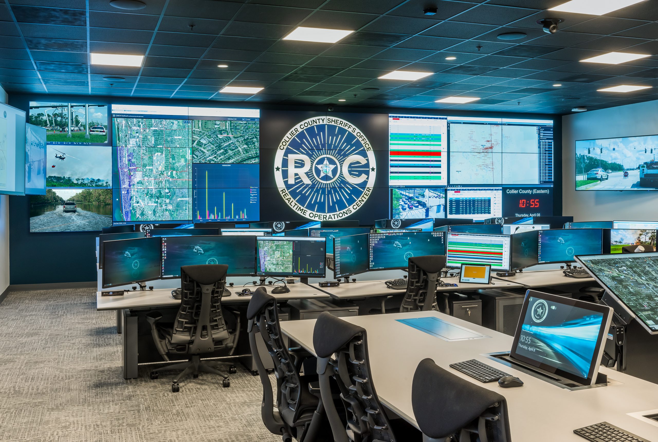 image of a realtime operations center with consoles and central video wall