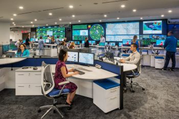 fleet operations center with staff at workstations large video wall display screens