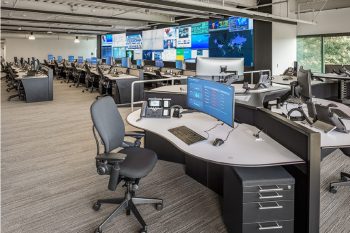 Large Operations Center with a mission-critical video wall and rows of 24/7 technology consoles