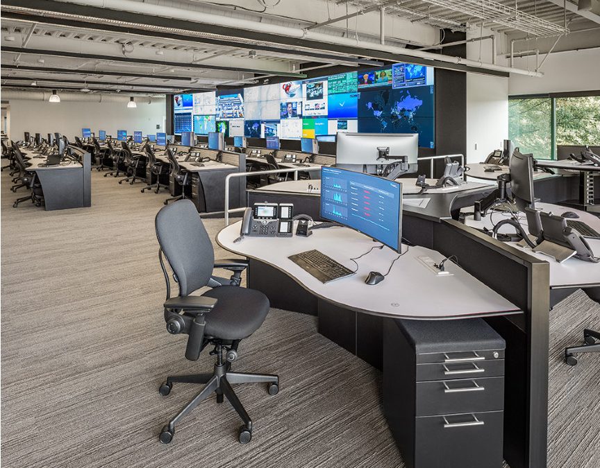 Large Operations Center with a mission-critical video wall and rows of 24/7 technology consoles