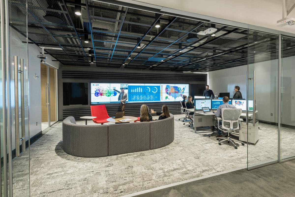 Social Media Command Center with video walls and consoles in the background