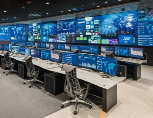 operations center with rows of consoles and large video wall