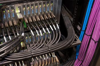 Organized AV equipment rack with labeled connections, cable management for mission-critical systems