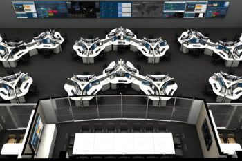 an aerial view of a control room with rows of desks and monitors