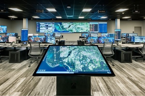 real time intelligence center with a touchscreen in the foreground and video wall in background