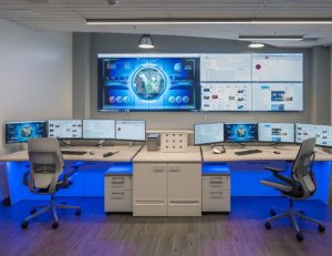 security operations center with video wall and two consoles featuring blue accent lighting