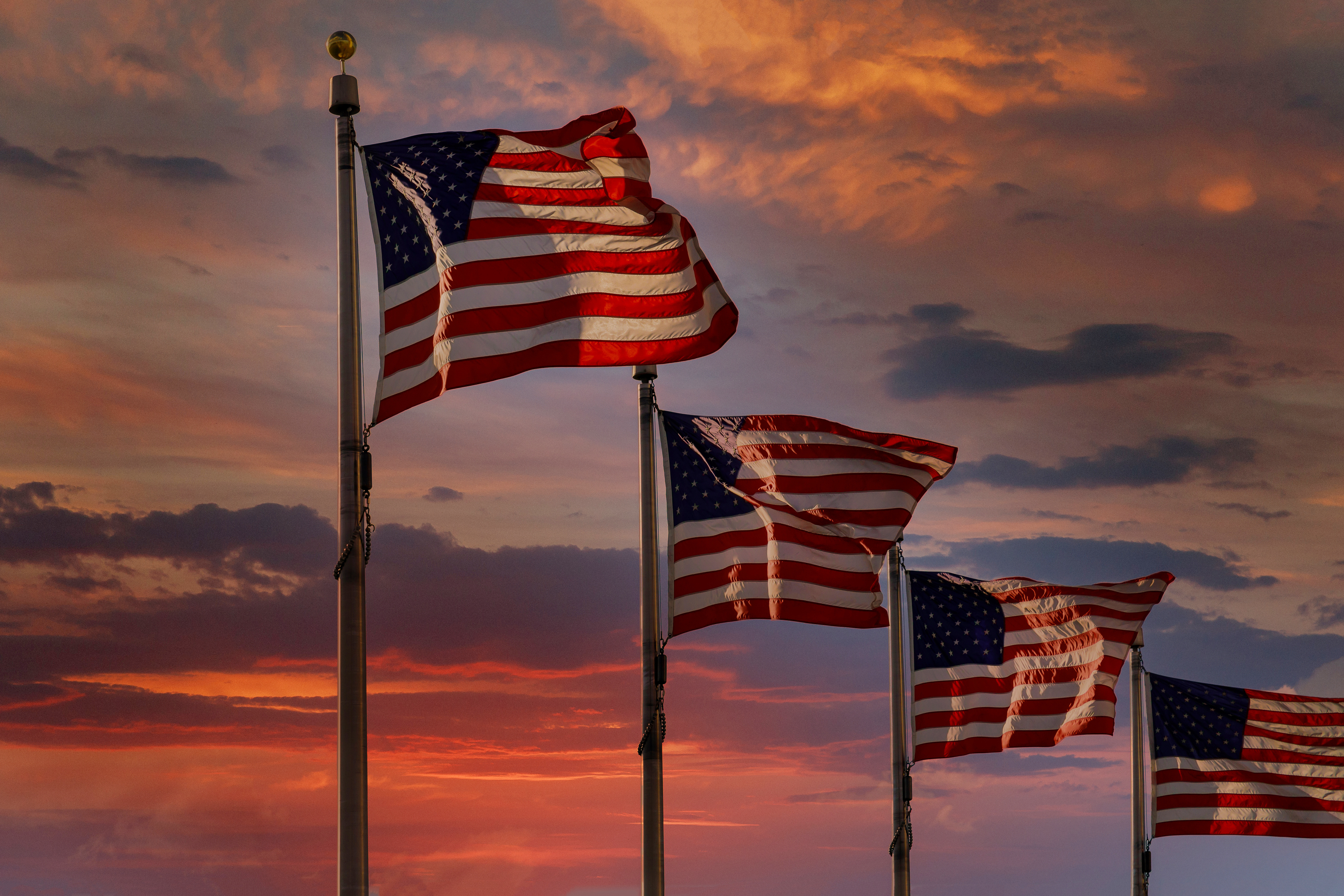 American flag backlit by waving large during scenic sunset