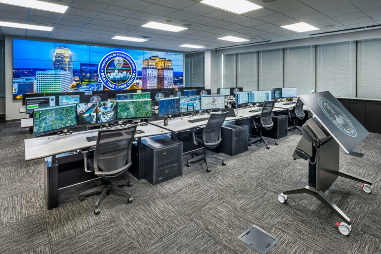 a room with a large screen that says winston-salem police
